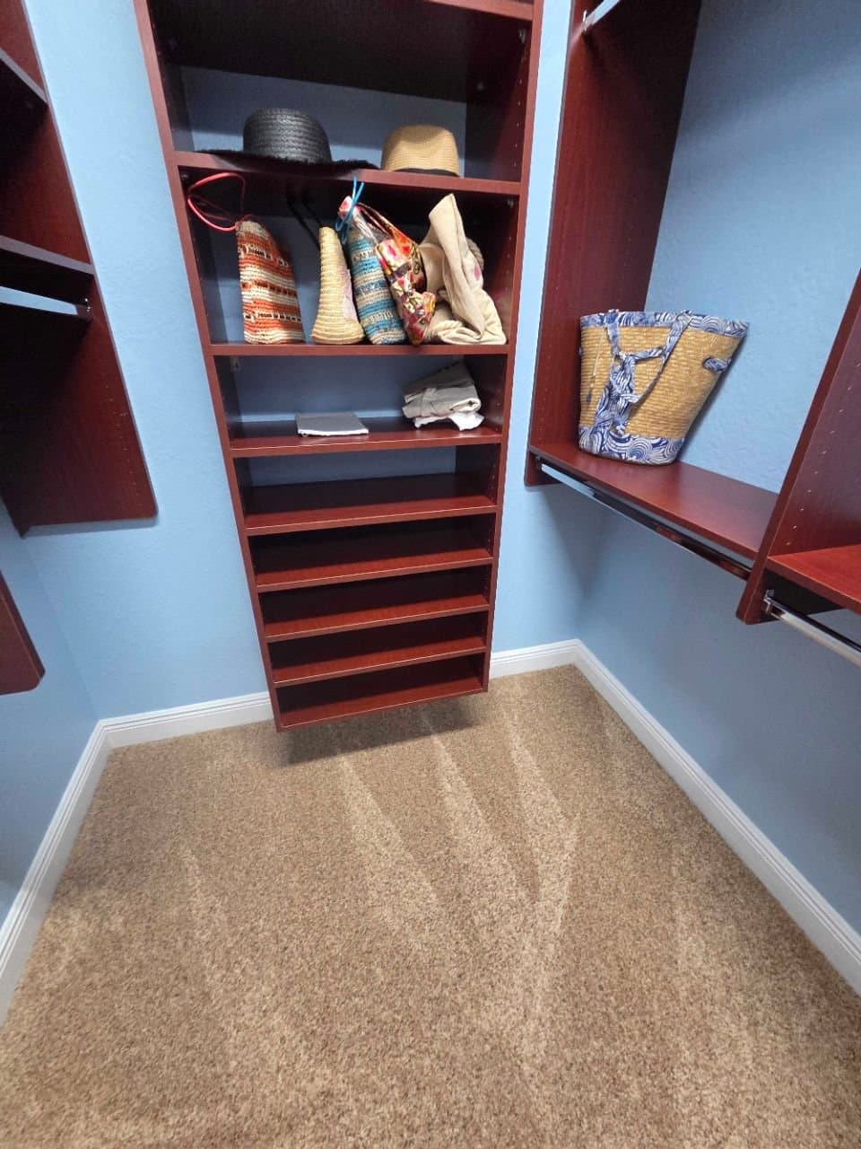 Walk-in closet shelving wiped down and carpet vacuumed
