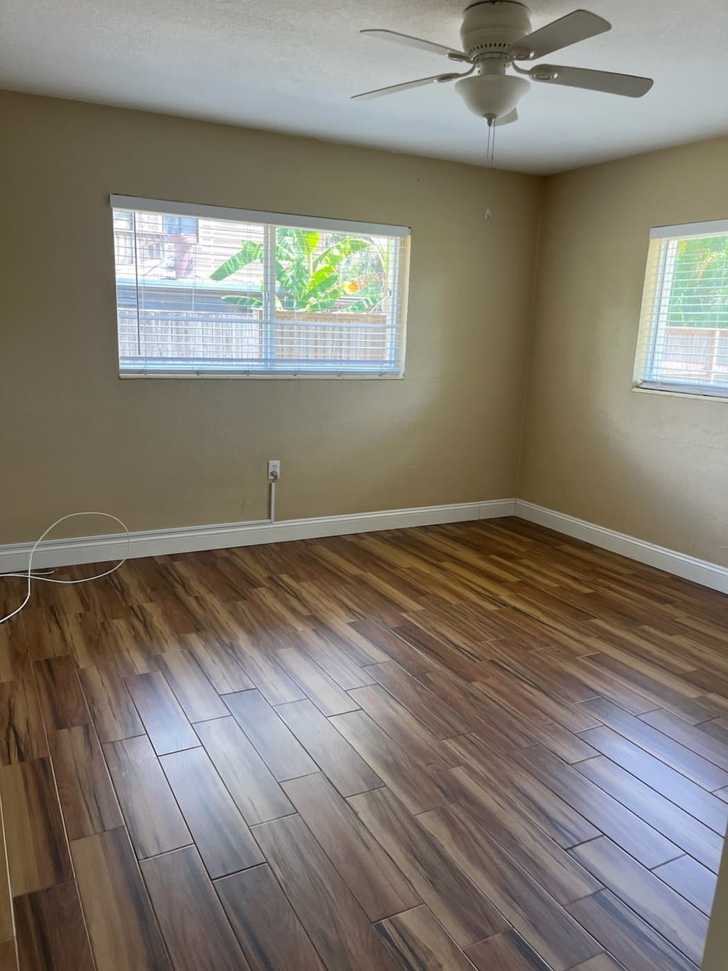 Fully vacant room with clean floors after a move-out clean