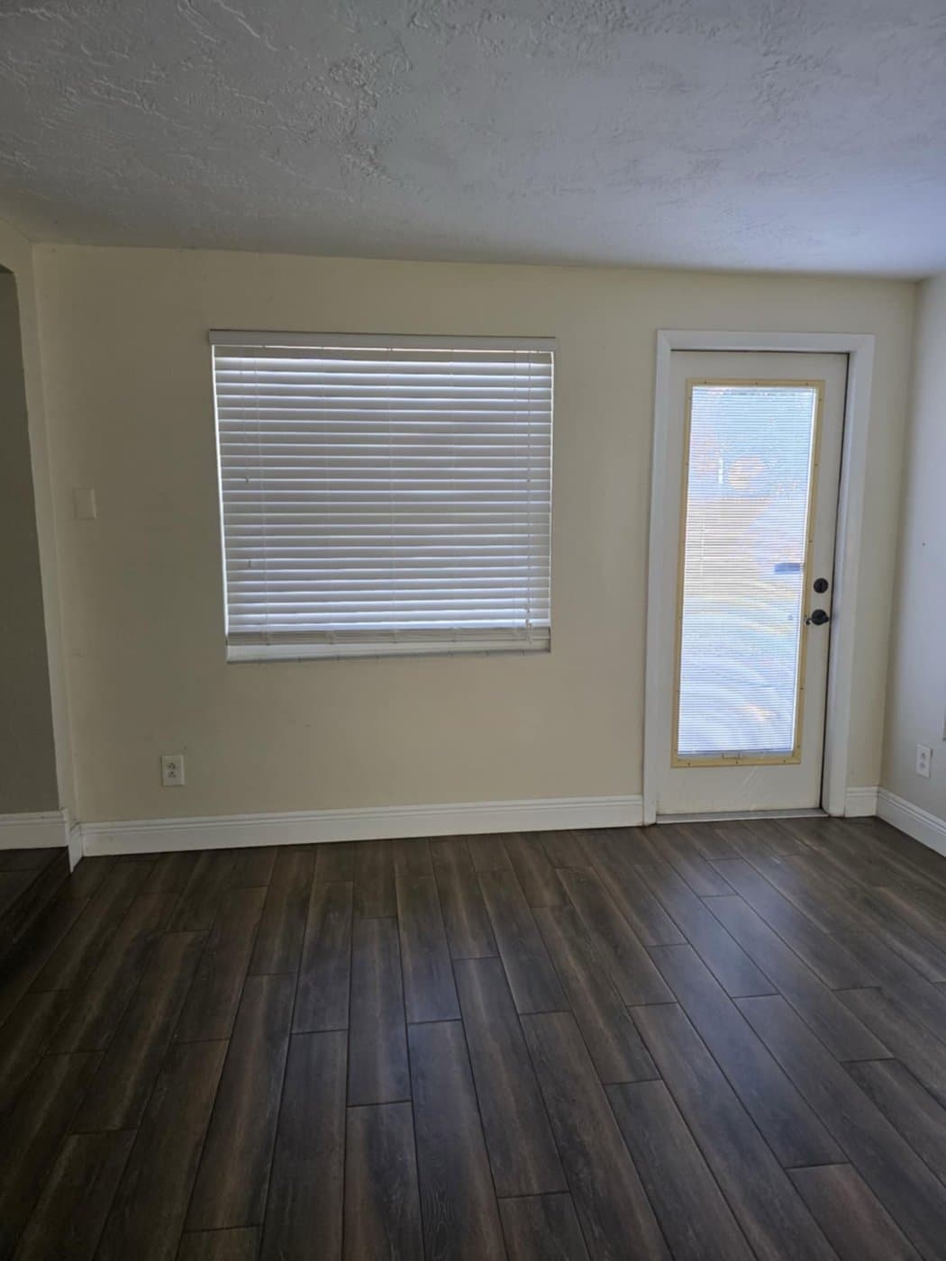 Vacant room with cleaned blinds and floors, ready for handoff
