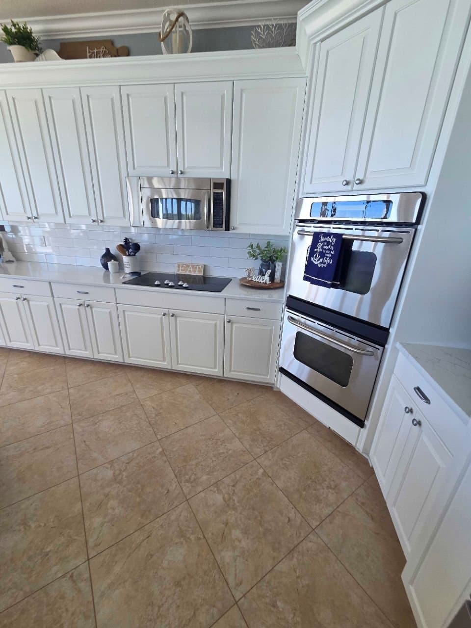 White kitchen with double wall oven after a turnover clean